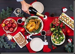 Baked turkey. Christmas dinner. The Christmas table is served with a turkey, decorated with bright tinsel and candles. Fried chicken, table.  Family dinner. Top view