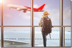 woman passenger tourist or traveller in late, delay checking in the gate terminal at boarding pass entrance, aircraft just leaving from the terminal