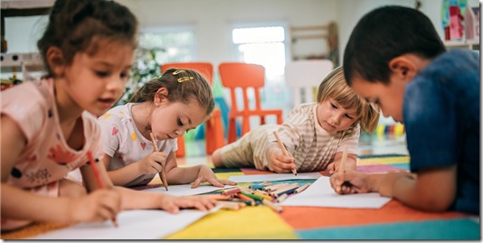 Group of preschoolers in art class painting pictures