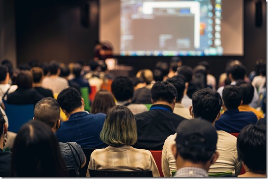 Rear view of Asian audience joining and listening speaker talking on the stage in the seminar meeting room or conference hall, education and workshop, associate and startup business concept